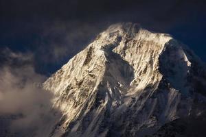 The sunlit, snow covered peak of Annapurna South on the Annapurna Base Camp trail in the Nepal Himalaya. photo