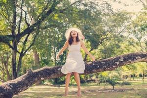 Young teen girl sitting on tree photo