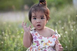 Cute girl smiling brightly in the setting sun photo