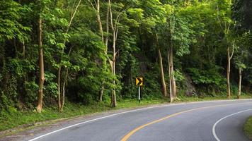 Sun in horizon over asphalt road photo