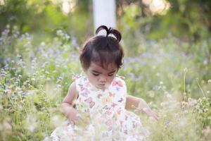 Cute girl smiling brightly in the setting sun photo