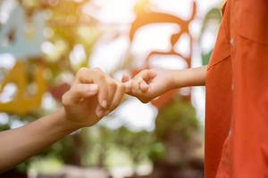 Happy couple holding hands in the sunset photo