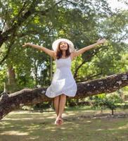 Young teen girl sitting on tree photo