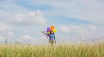 Beautiful Girl jumping with balloons on the beach photo