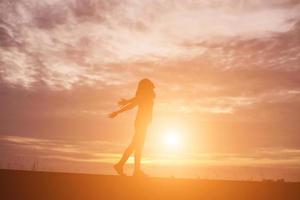 Young woman raise hands up for her success, Concept of Success in life. photo