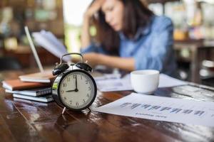 Young woman sitting in a cafe with her laptop, Stressful for work. photo