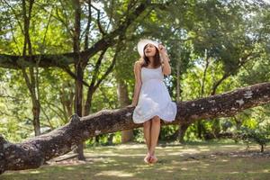 Young teen girl sitting on tree photo