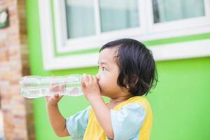 Thirsty Girl Drinking Water Outdoors photo