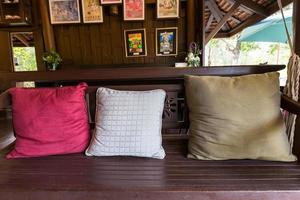 wooden chair with  pillows photo