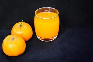 Glasses of orange juice and fruits photo