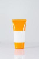 Cosmetic sunscreen tube on white photo