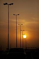 Sun setting on a highway photo