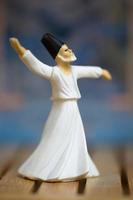 Macro photo of a small statue of a Sufi dancing the dance of Sama