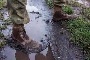 close up army boots in dirt water photo