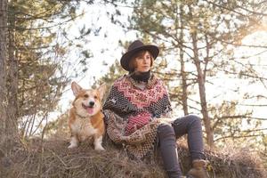 mujer joven hipster viaja con perro corgi foto