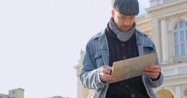 Young male traveler with map in the city video