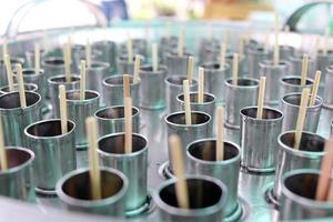 Bamboo sticks in stainless tubes are making ice cream, Thailand. photo