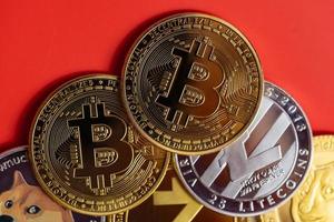 bitcoin BTC and Dogecoin DOGE group included with Cryptocurrency coin , Ethereum ETH, Bitcoin Cash bch, Litecoin LTC symbol Virtual blockchain technology future is money lose Closeup on red background photo