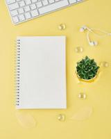 Blank notepad page in bullet journal on bright yellow office desktop photo