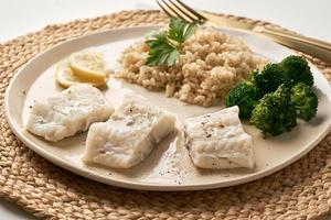 Steamed cod with brown rice and vegetables, dash fodmap diet side view photo