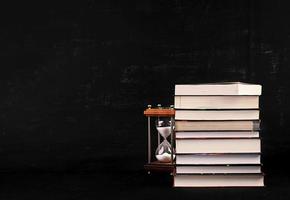 Stack of different books on dark background. Knowledge concept. photo