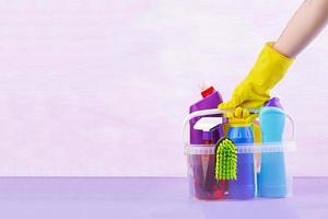 Cleaning service concept. Colorful cleaning set for different surfaces in kitchen, bathroom and other rooms. photo