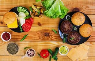 Ingredients for burger on wooden background. Top view photo