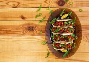 Mexican tacos with beef in tomato sauce photo