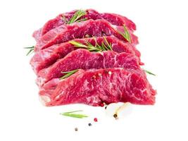 Raw meat, beef steak with seasoning on white background, side view photo