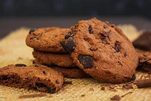 Cookies with chocolate on dark wooden background photo