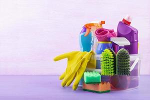 Cleaning service concept. Colorful cleaning set for different surfaces in kitchen, bathroom and other rooms. photo