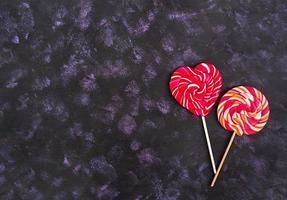 Colorful lollipops on dark background. Top view