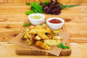 Baked potato with sauce and spices on dark background photo