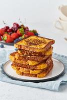 French toasts with berries, brioche breakfast, white background, vertical closeup photo