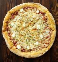 Four cheese pizza with Dor-blue, Parmesan, feta, oregano, mozzarella, tomato sauce, top view photo
