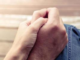 Two hands together, a man and a woman holding hands. Husband and wife together. Support and understanding photo