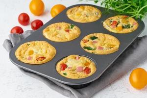 omelet with tomatoes and bacon, baked eggs with spinach and broccoli, closeup, keto, ketogenic diet photo