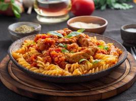 Bolognese pasta. Fusilli with tomato sauce, ground minced beef photo