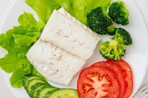 Steamed cod fish. Paleo, keto, fodmap healthy diet with vegetables photo