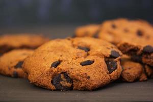 Cookies with chocolate on dark wooden background photo