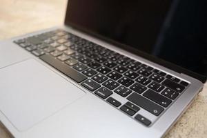 Image of laptop keyboard English and Thai alphabet with selective focus background. photo