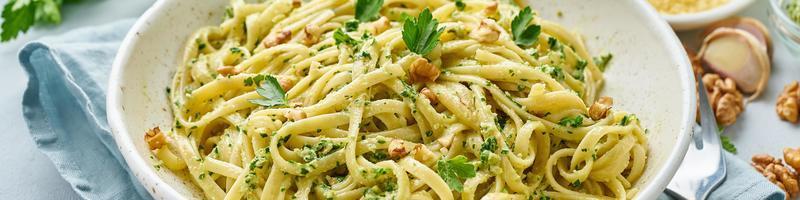 Banner with pesto pasta, bavette with walnuts, parsley, garlic, nuts, olive oil photo