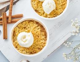 Apple crumble with ice cream, streusel. Morning breakfast on a light gray table. Top view, close up photo