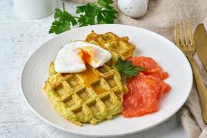 Zucchini waffles with salmon and benedict egg, fodmap diet side view closeup photo