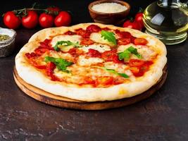 hot homemade Italian pizza margherita with mozzarella and tomatoes photo