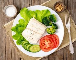 Steamed cod fish. Paleo, keto, fodmap healthy diet with vegetables photo