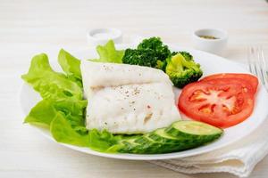 Steamed cod fish. Paleo, keto, fodmap healthy diet with vegetables photo