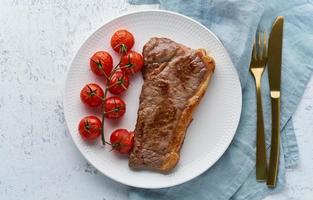 keto ketogenic diet steak with tomatoes on white background, top view photo