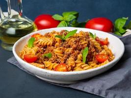 Bolognese pasta. Fusilli with tomato sauce, ground minced beef photo