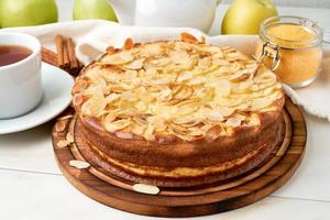 Cheesecake, apple pie, curd dessert with polenta, apples, almond flakes photo